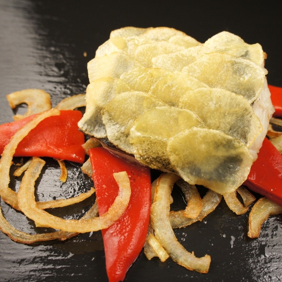 Sargo with crispy potato slices, piquillo peppers and sautéed